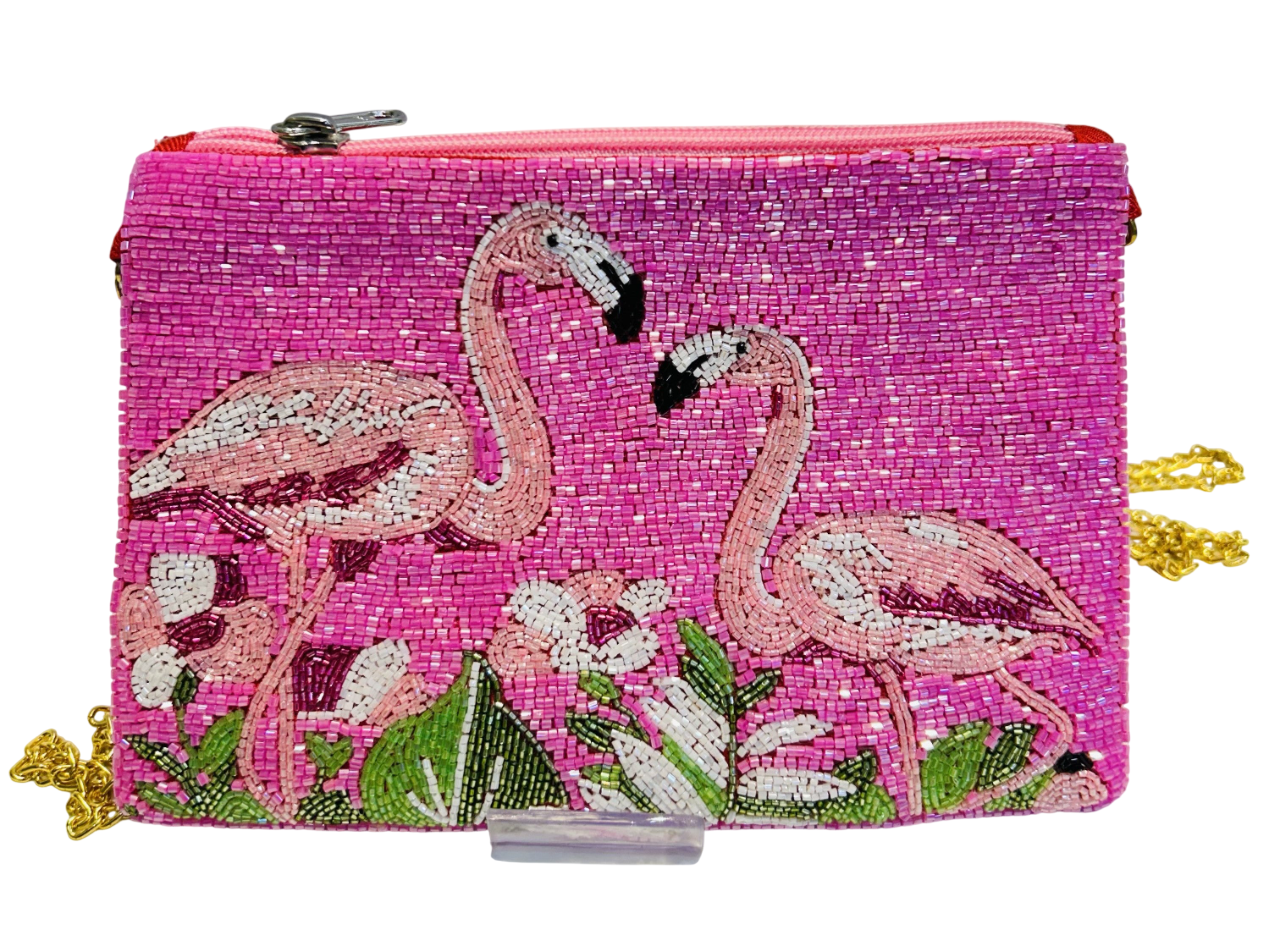 The Handmade Pink Flamingo Beaded Purse is a tropical summer clutch featuring two flamingos amid green leaves and white flowers, a pink zipper, and a 46" detachable gold chain strap.