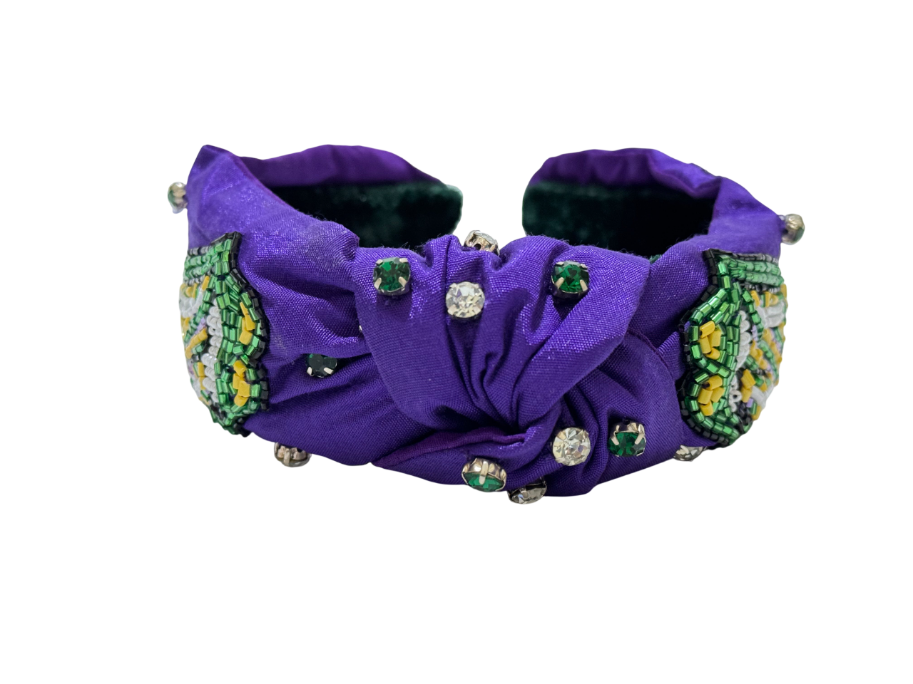 The Mardi Gras Green Tongue Beaded Knot Headband is a vibrant festival hair accessory with purple fabric, green and yellow beads, rhinestones, and green gems—perfect for making a statement against a crisp white background.