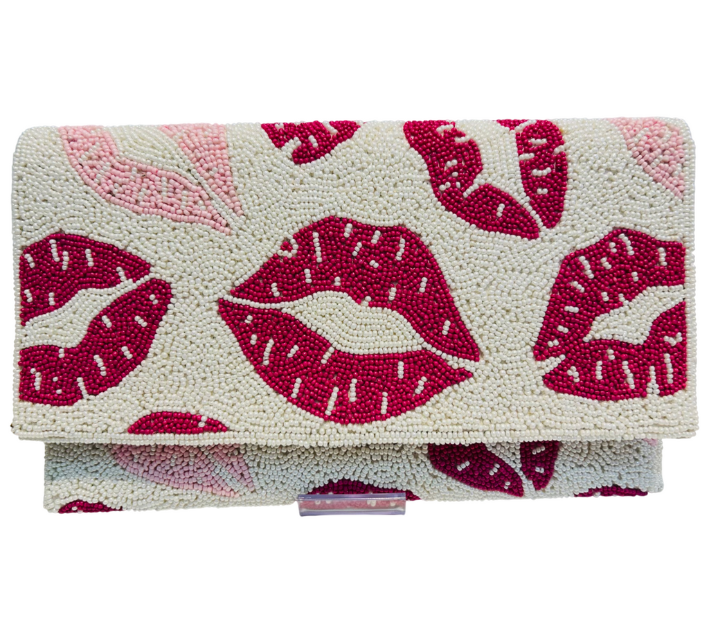 The Hand-crafted Valentine's Day Special Beaded Purse is a rectangular clutch adorned with small beads and playful red and pink lips on a cream background—a charming accessory for your Valentine’s outfit.