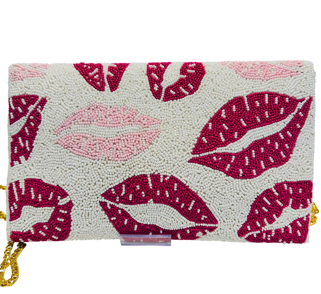 The Hand-crafted Valentine’s Day Special Beaded Purse features red and pink beaded lip prints on a white background, finished with a gold chain strap—making it the perfect playful accessory for Valentine’s Day.