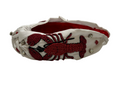 Add a playful touch to your Mardi Gras look with the Lobster Mardi Gras Beaded Headband, featuring white fabric, red beaded lobster design, sparkling silver rhinestones, and a textured red inner lining.