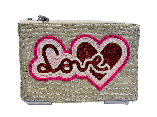 The Love and Hearts Hand-Beaded Zipper Clutch is a handcrafted beige pouch featuring “Love” in pink and red seed beads with a heart design, detailed beadwork, secure top zipper, and includes 46 detachable pieces.