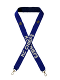 The KC Chiefs Gameday Beaded Purse Strap features a blue and white design with gold stars, white KC CHIEFS text on each side, and sturdy metal clips at both ends—perfect for football fans.