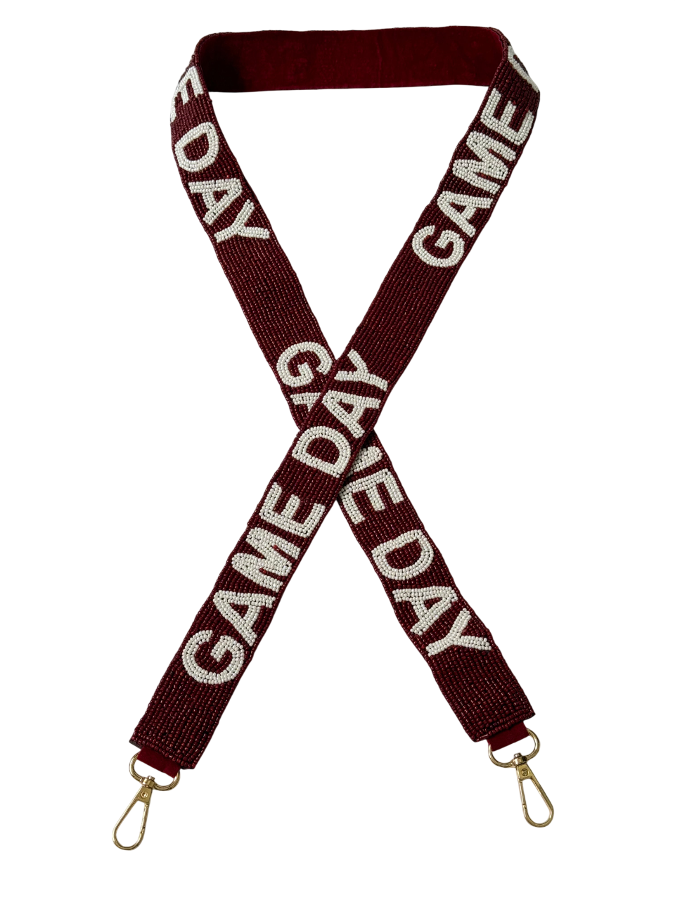 The Gameday Maroon & White Beaded Purse Strap features gold clips at both ends and repeated white "GAME DAY" text, arranged in a stylish crisscross for football fans.